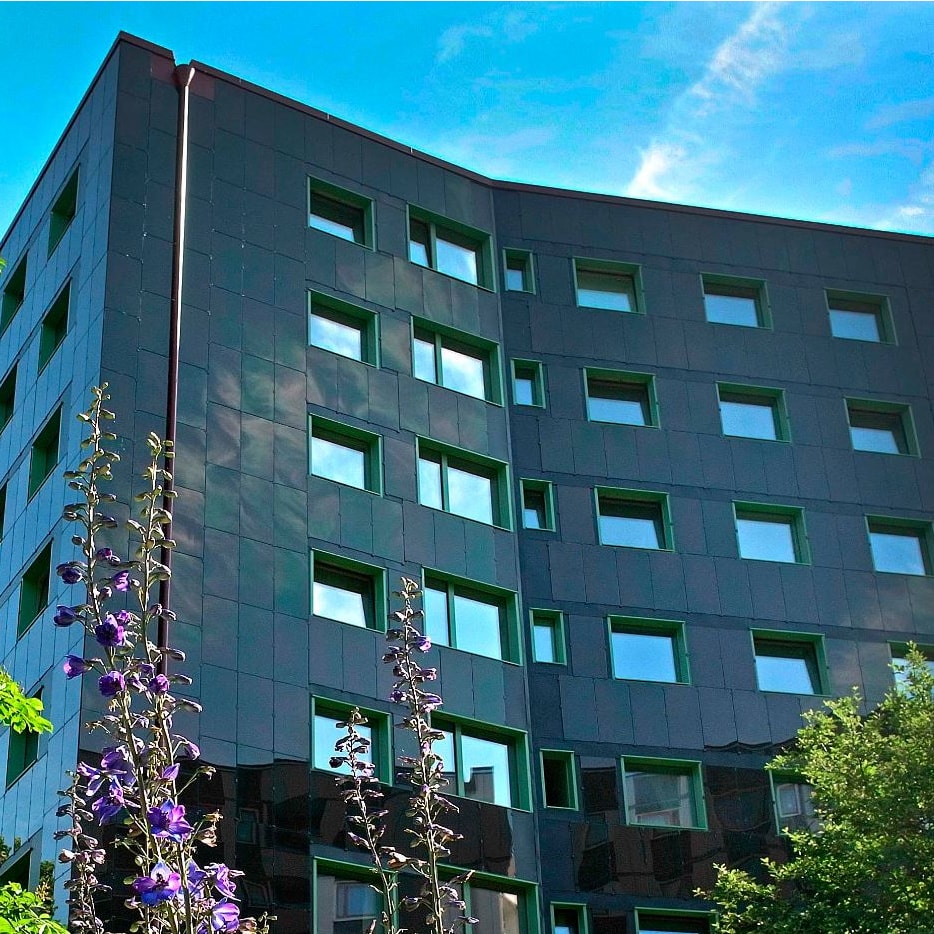 Grått höghus en himmelsblå dag